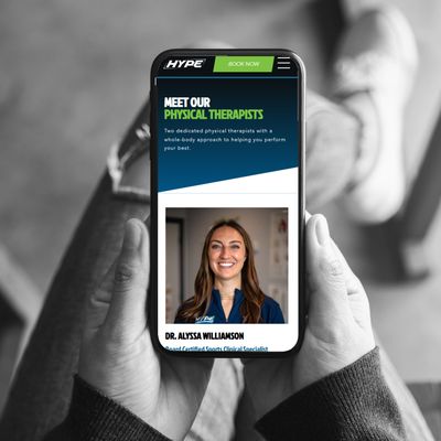 person holding a mobile phone with the screen showing the HYPE Meet Our Therapist page